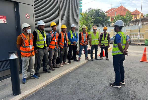 Capital Arts technicians installing façade signage at Sathapana Tower, Phnom Penh.
