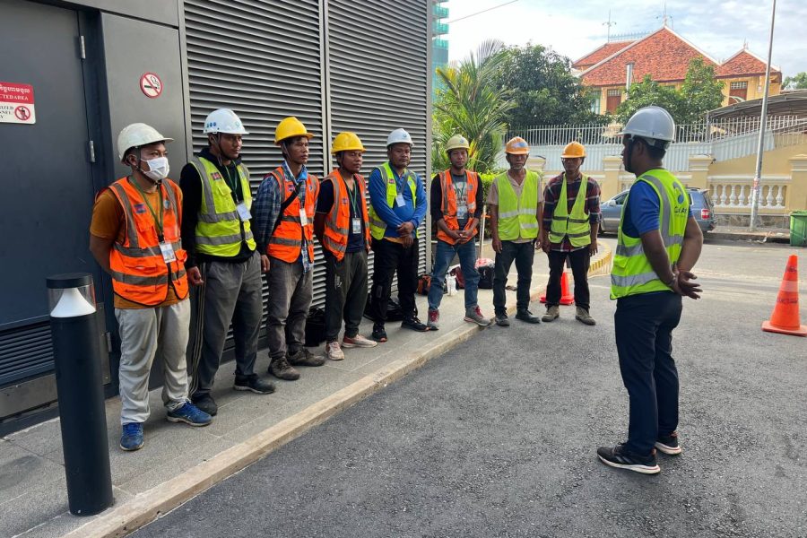 Capital Arts technicians installing façade signage at Sathapana Tower, Phnom Penh.